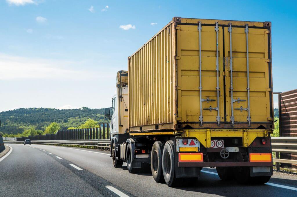 A lorry driving down a road.
