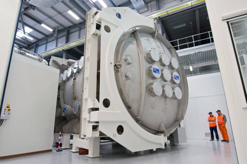 A large, cylindrical Satellite Test Chamber.