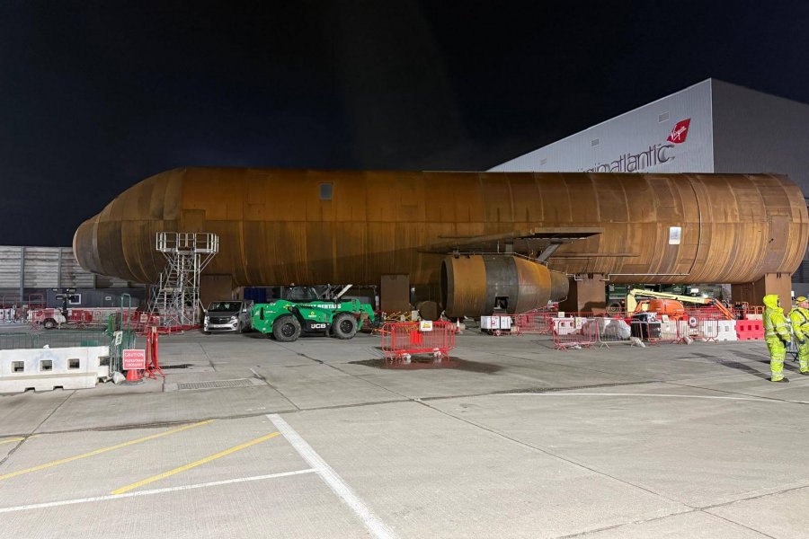 Workers preparing heavy machinery for lifting operation