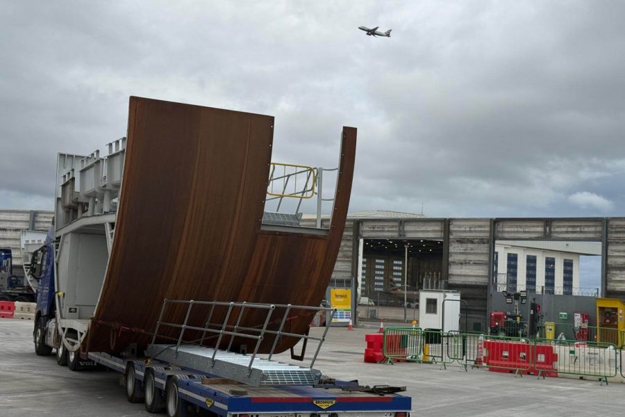 Large curved steel structure on a flatbed trailer