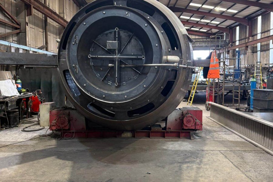 Large cylindrical engine component inside a warehouse